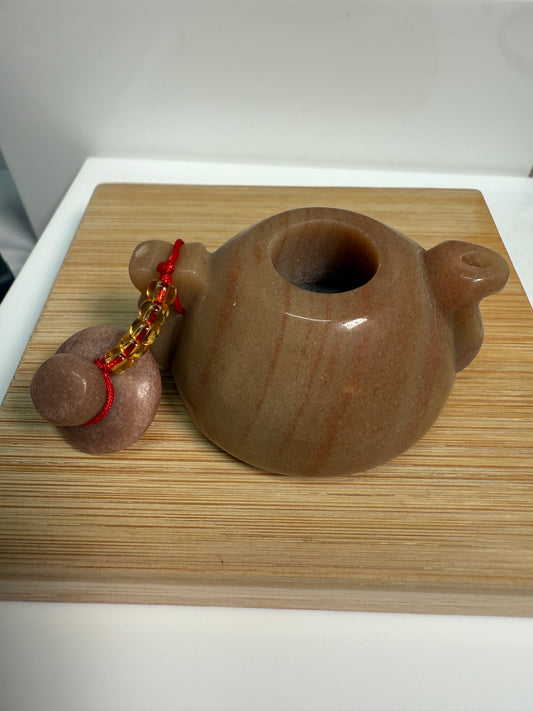 Golden Jasper crystal teapot figurine with warm honey-brown tones and earthy patterns, 2 inches long, shown with lid off.