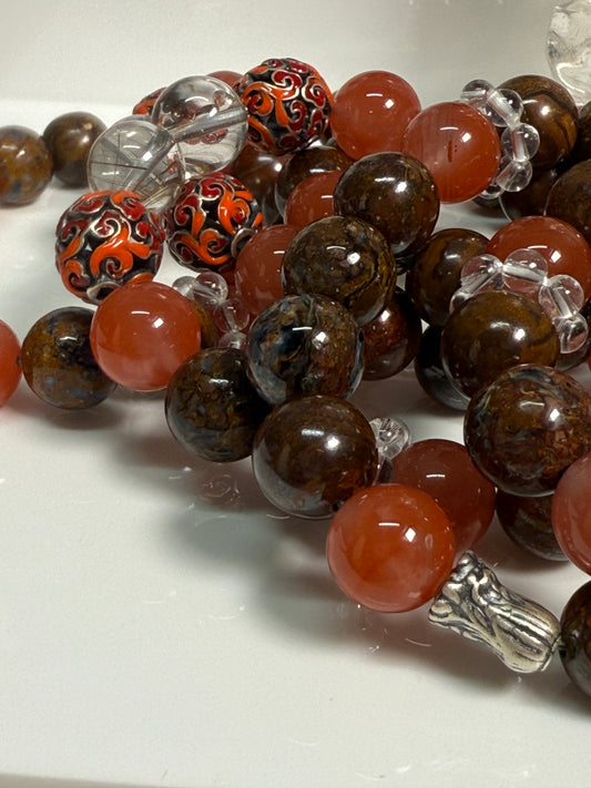 Crystal bracelet featuring South Red Agate, Pietersite, Rutile-in-Quartz, and Brown Opal, with 925 sterling silver cabbage and enameled beads, accented by a clear quartz ring. A sculptural fine jewelry piece symbolizing growth, clarity, and inner resilience.