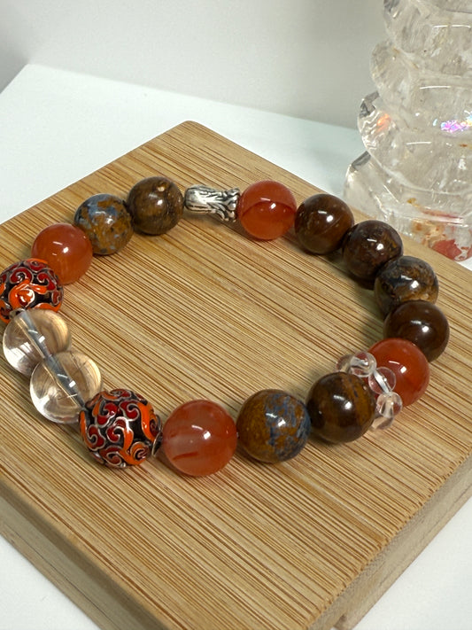 Crystal bracelet featuring South Red Agate, Pietersite, Rutile-in-Quartz, and Brown Opal, with 925 sterling silver cabbage and enameled beads, accented by a clear quartz ring. A sculptural fine jewelry piece symbolizing growth, clarity, and inner resilience.